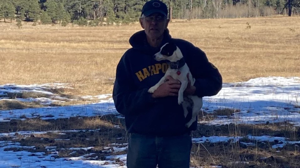 old man holding a dog